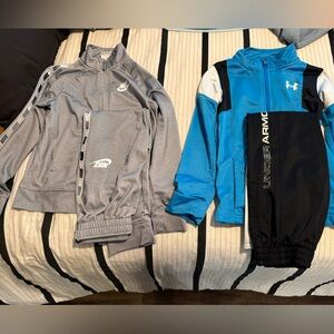 Boys Nike Gray track suit and blue and black Under Armour track suit.